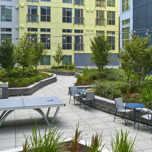 Thoughtful details to elevate your lifestyle a courtyard with tables and chairs